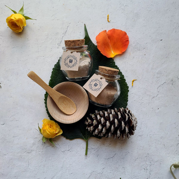 Featherlight Foundation jar and Featherlight Veil jar wooden bowl and wooden spoon roses, leaves, pine cone